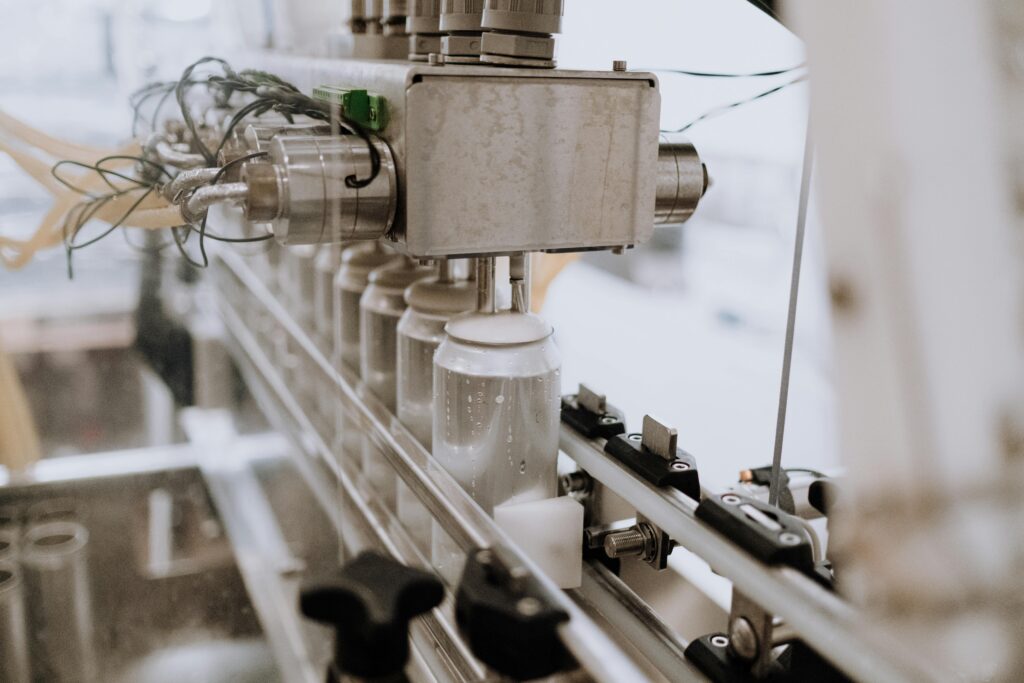 Bottle filling line with distance laser and string potentiometer sensors